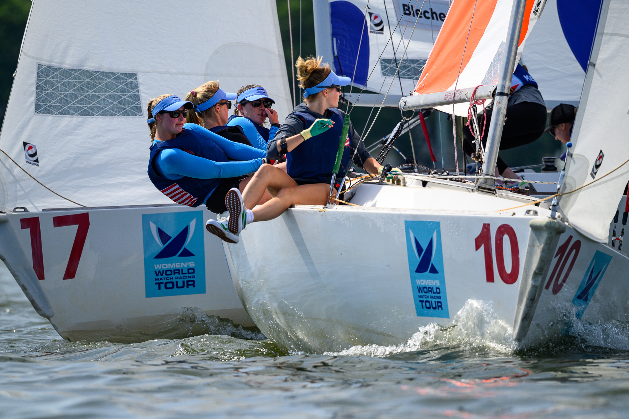 Crew hiking hard aboard boat 10 during a match race